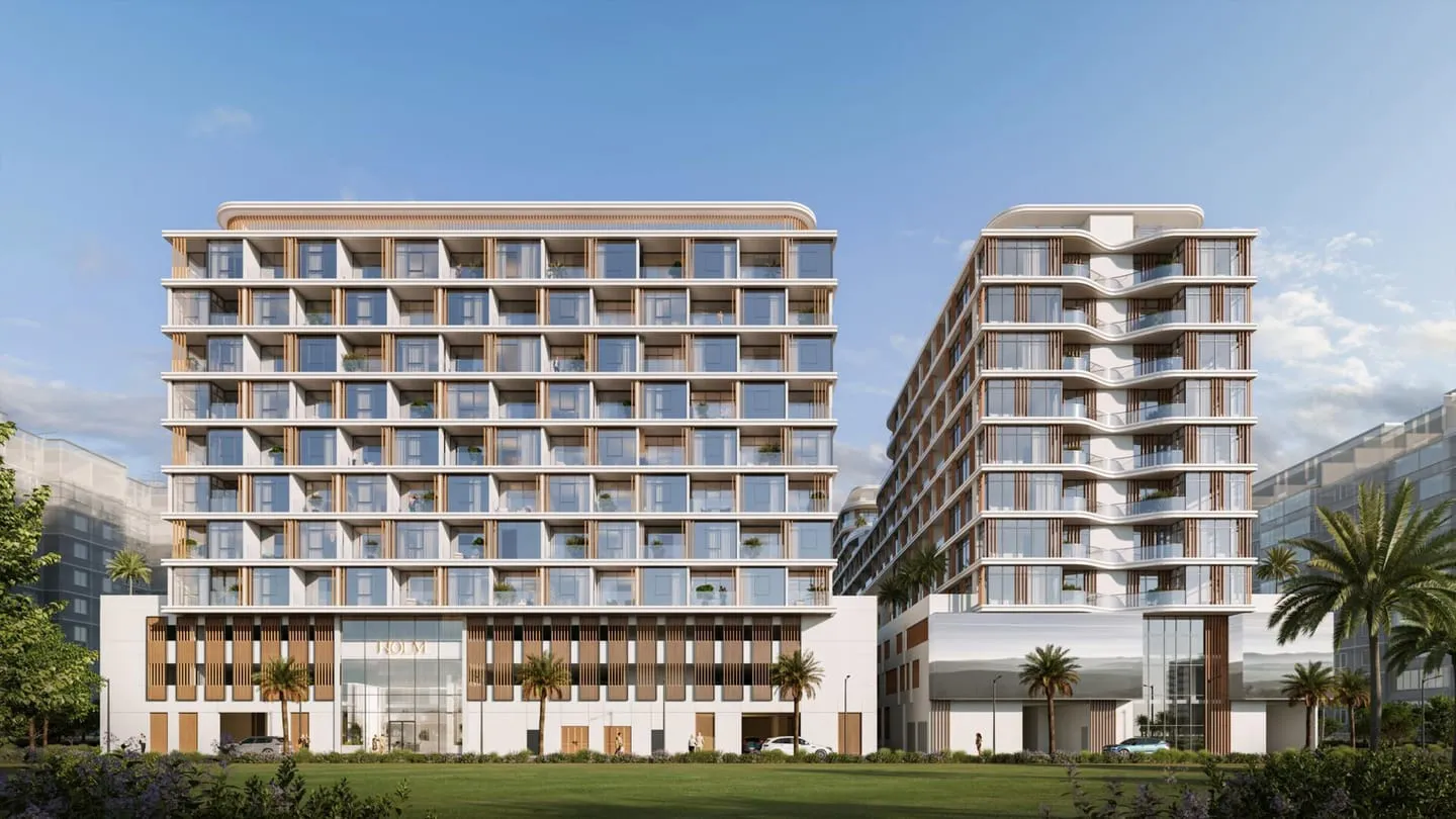 The building seen across a landscaped lawn, its timber-fin facade under a clear sky
