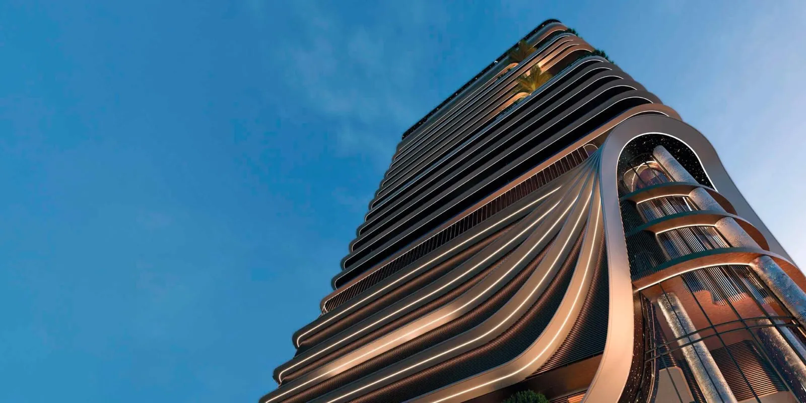 Looking up the facade from the street, the ribbed balcony edges narrowing against a clear blue sky