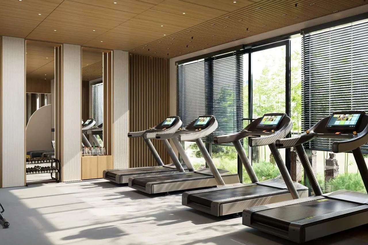 The building's fitness studio, lined with treadmills beneath a slatted wood ceiling