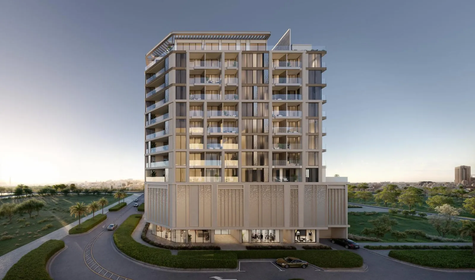The front elevation at first light, balconies set back behind the frame and the ground floor glazed along the podium