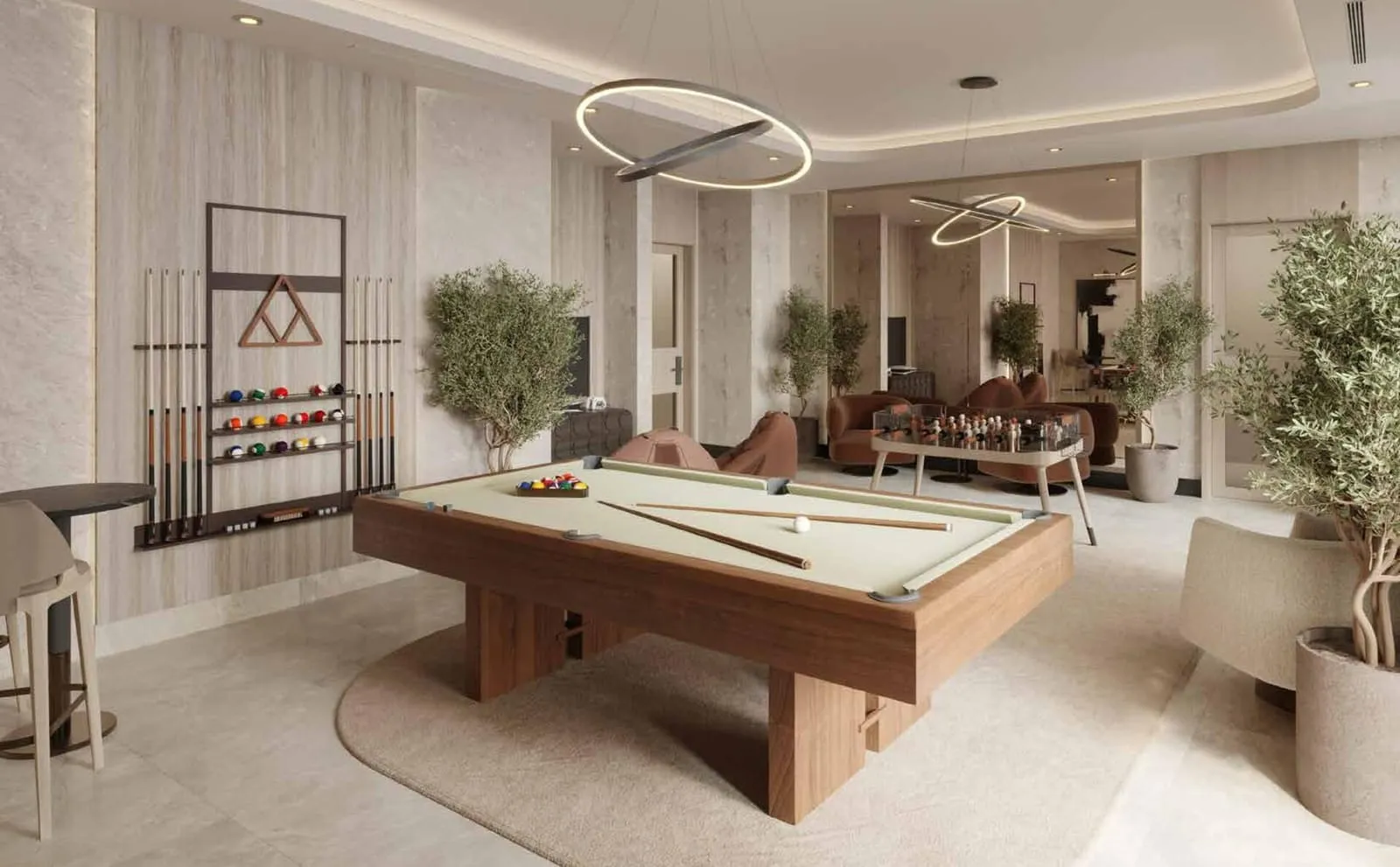 The residents' games lounge with a billiard table, a cue rack on the stone wall and a foosball table beyond