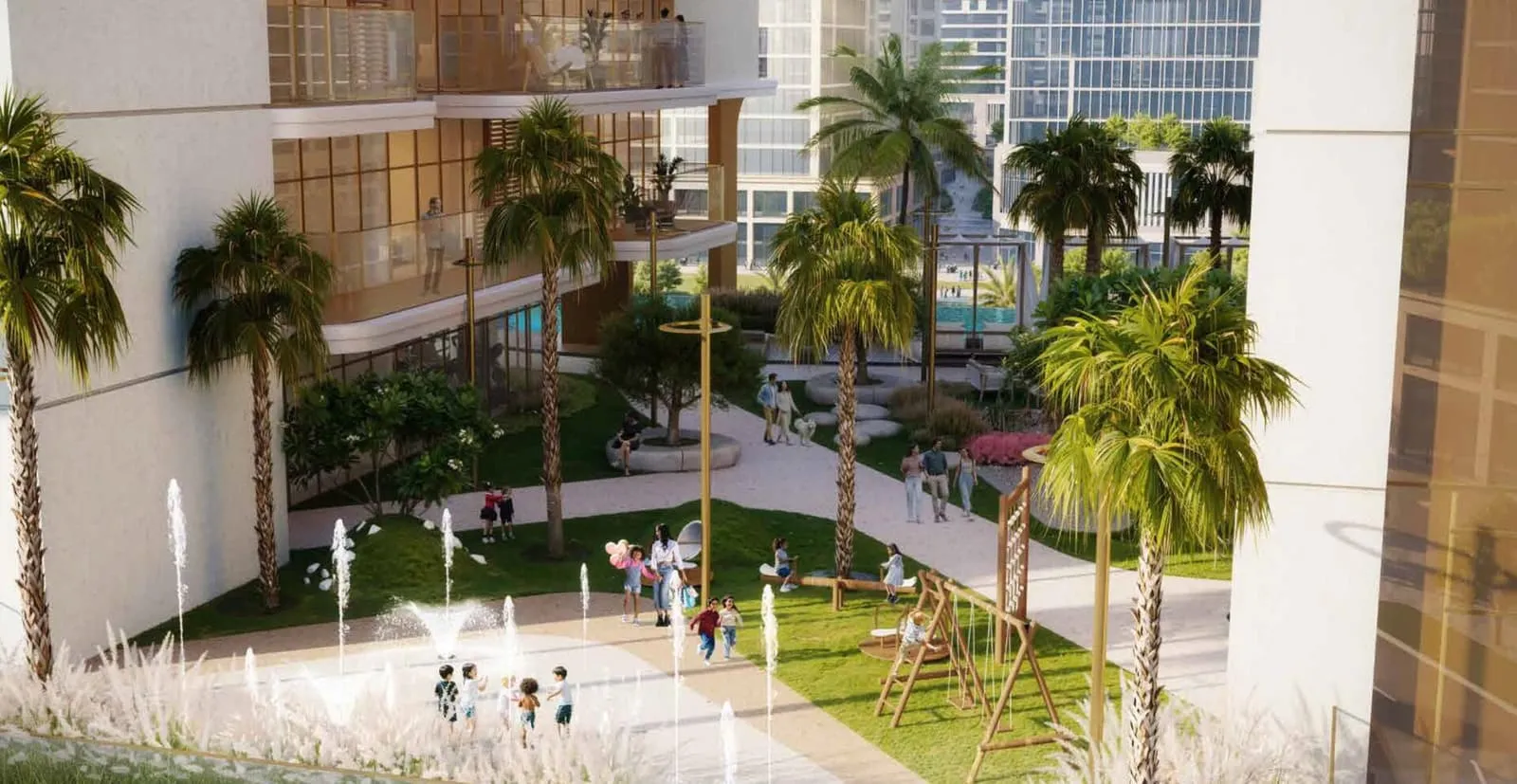 A planted courtyard with a play area for children, palms along the paved path and a green screen behind