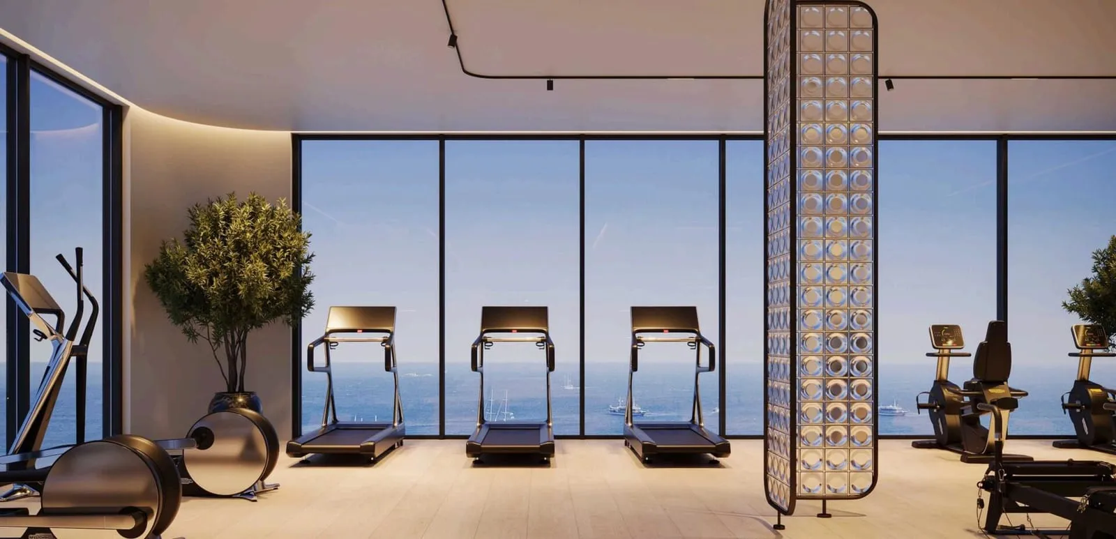 Treadmills lined up at floor-to-ceiling glazing in the gym, with a gilded screen and planters to one side