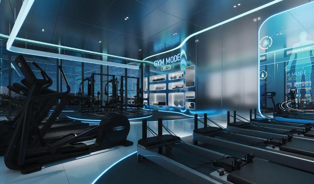 The cardio floor of the gym, treadmills in a row facing wall screens under blue ceiling light