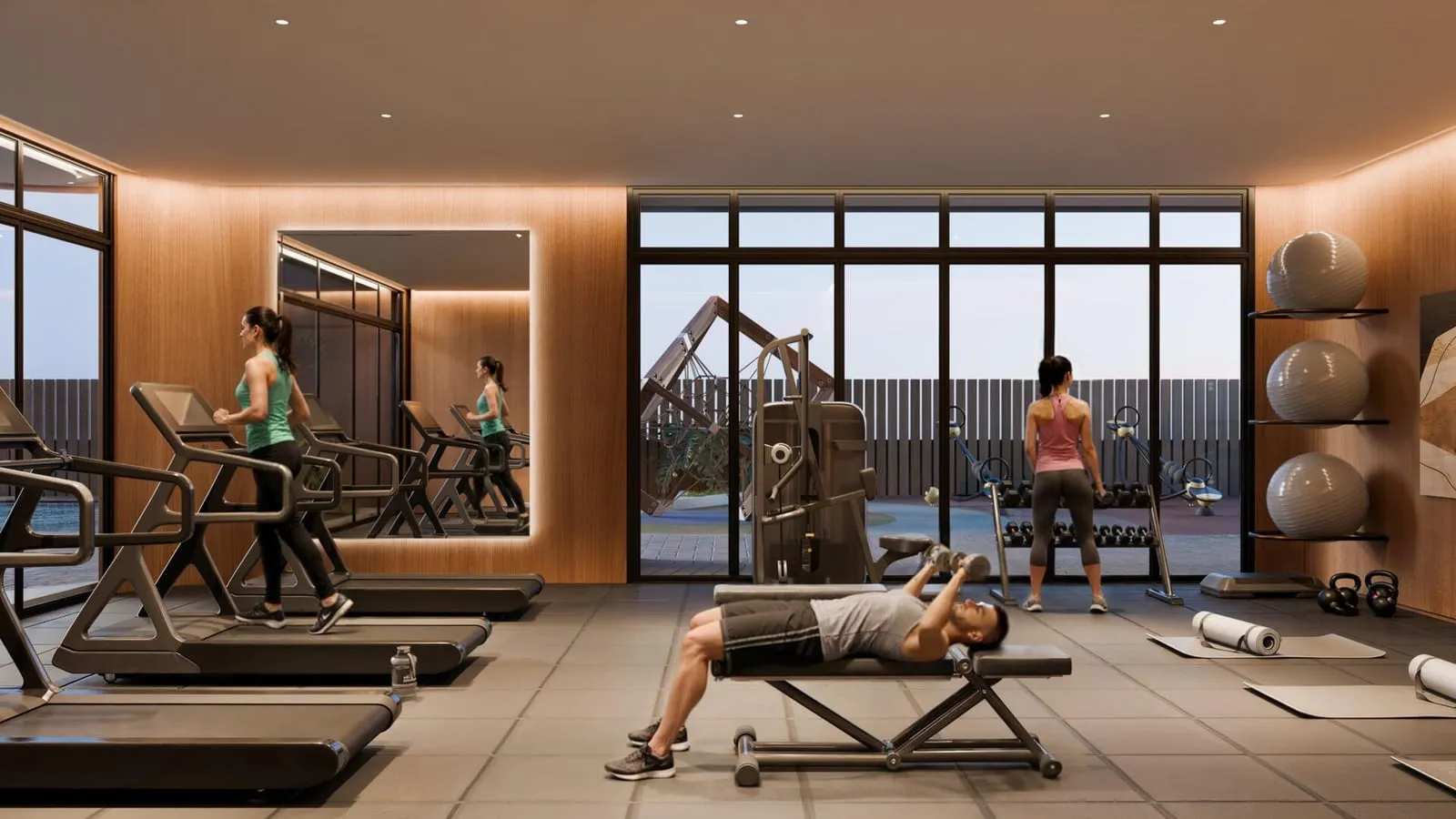 A fully equipped fitness centre with treadmills and strength training stations.