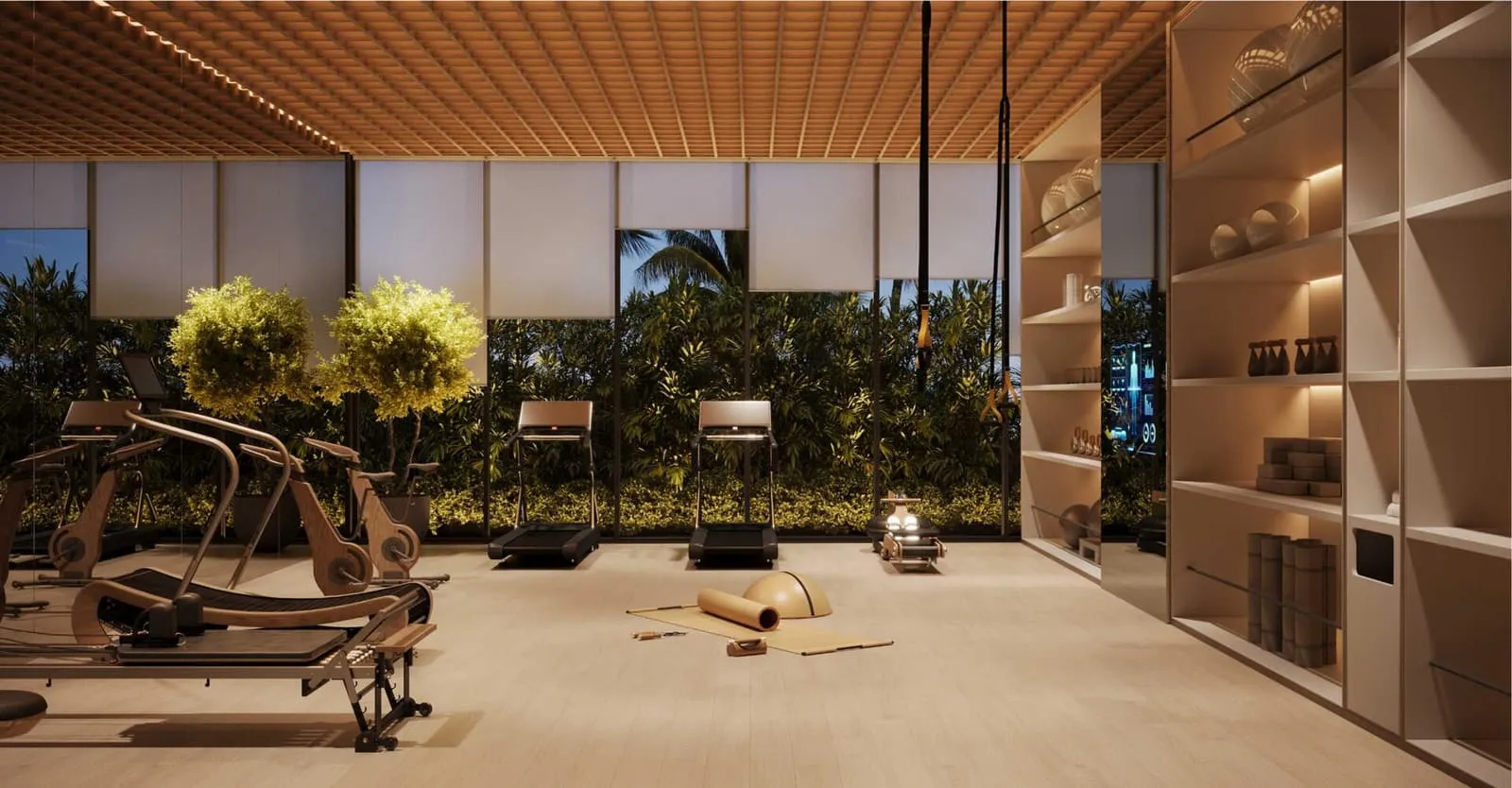 The gym under a timber-slatted ceiling, machines lined up beside glazing that opens to greenery