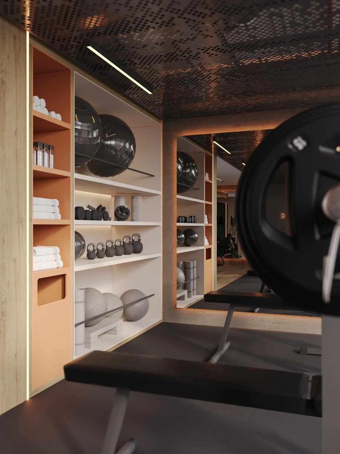 Gym storage, folded towels and dumbbells on timber shelves with a weight plate leaning at the right