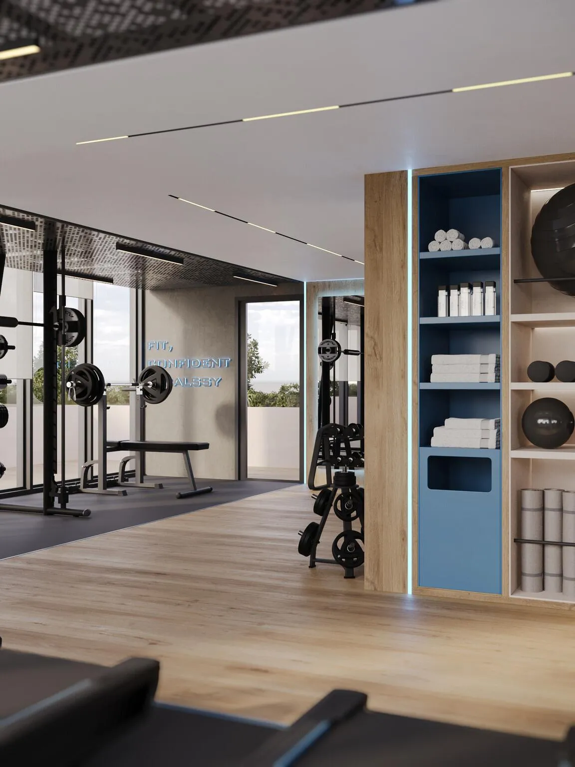 The gym on timber flooring, a barbell rack beside blue shelving stacked with towels and equipment, windows to the right