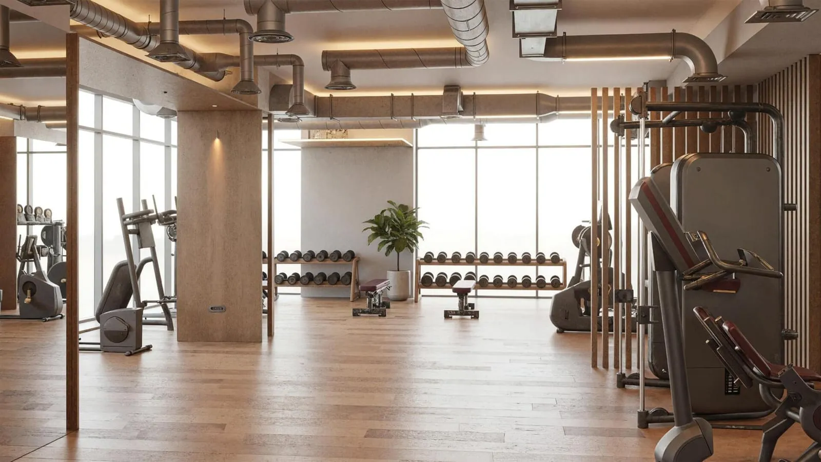 A fully equipped gym with wood flooring and floor-to-ceiling windows