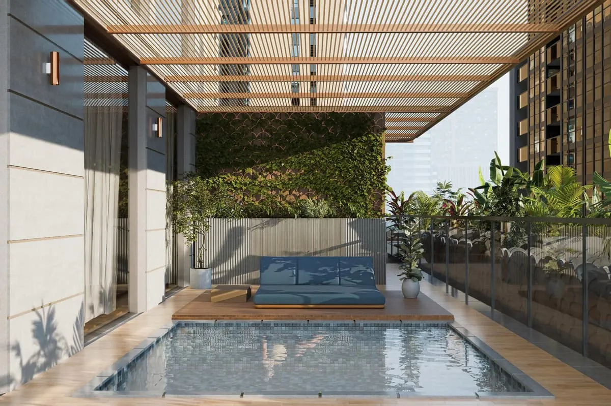 A glass-walled swimming pool area glowing under evening lighting