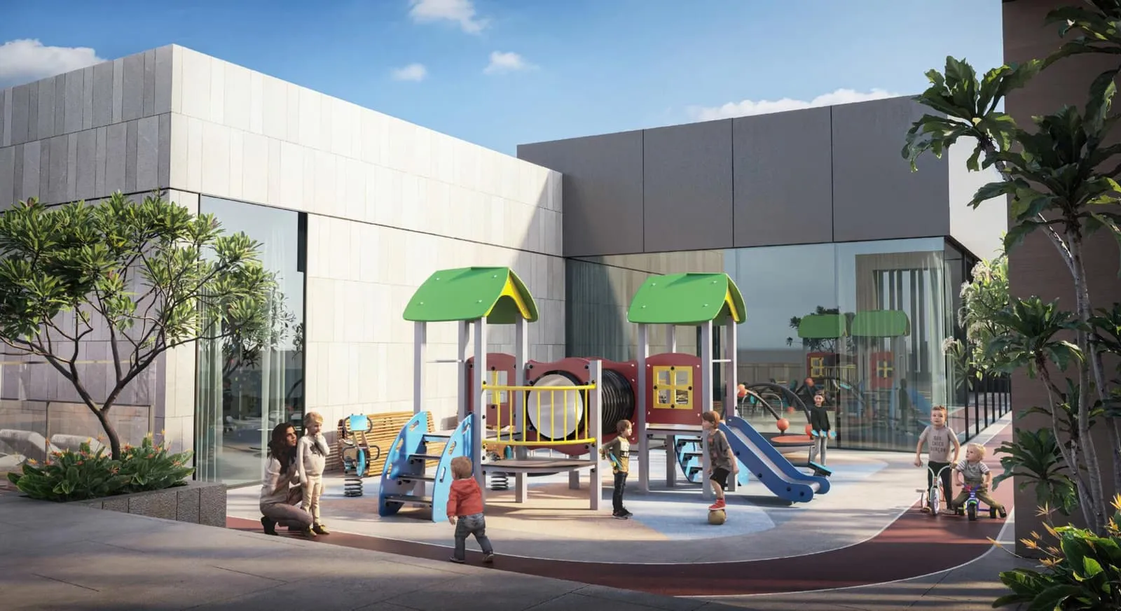 The outdoor children's play area, slides and climbing frames under green shade canopies beside the building