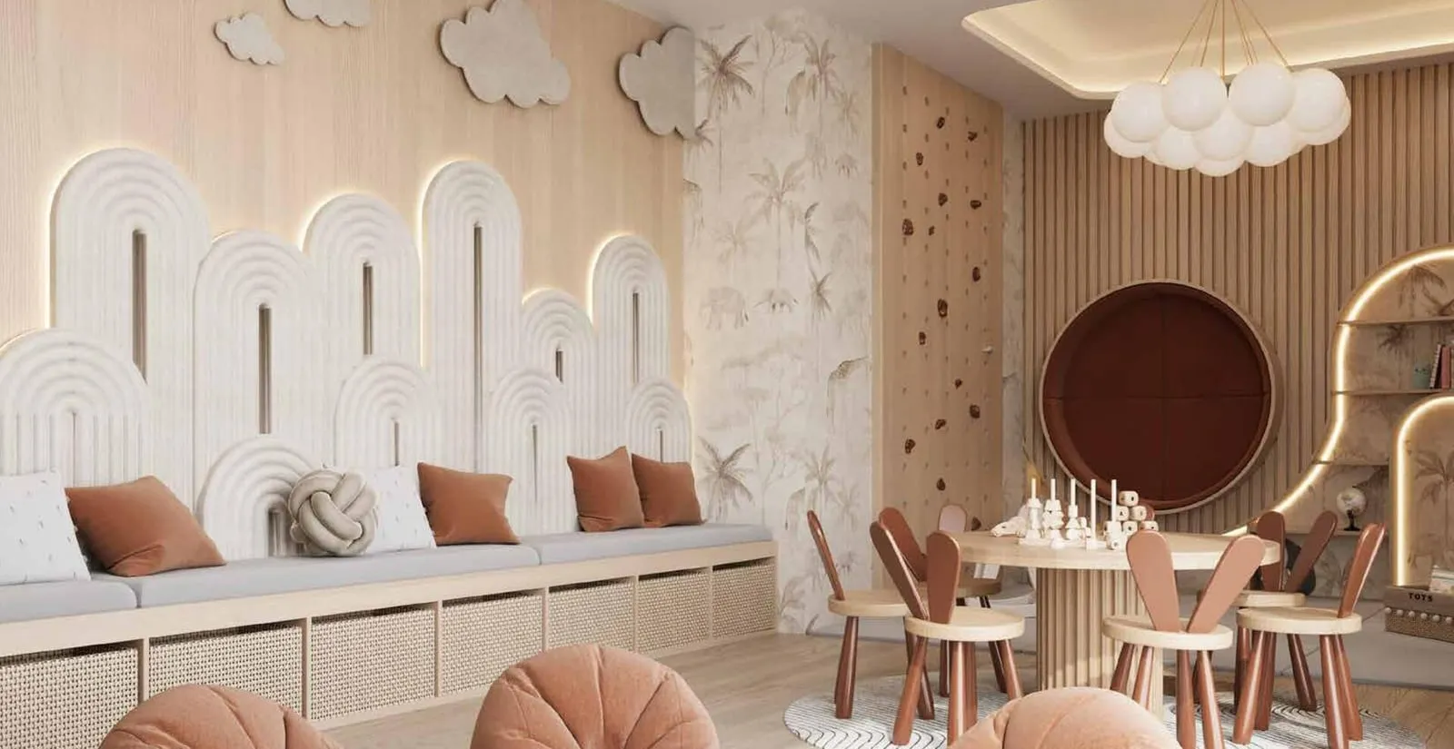 An indoor children's playroom with pastel arches, cloud motifs and a low table with small chairs