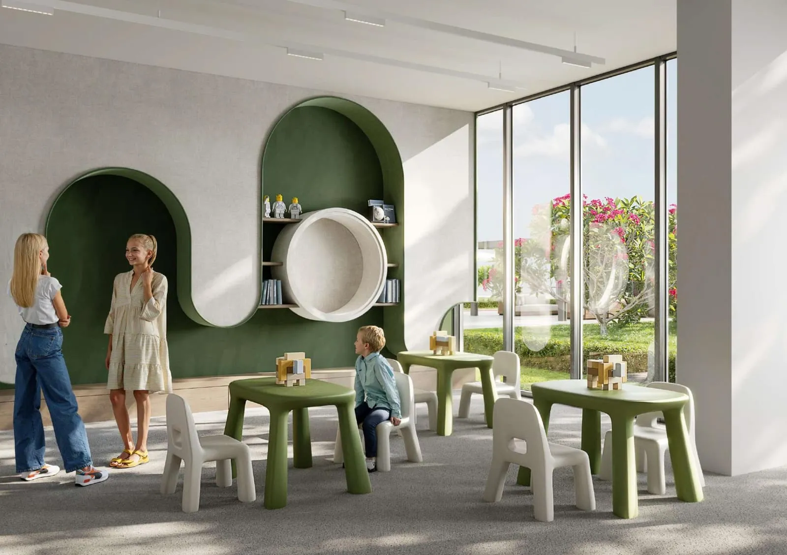 The indoor kids room, low tables and chairs inside arched green joinery