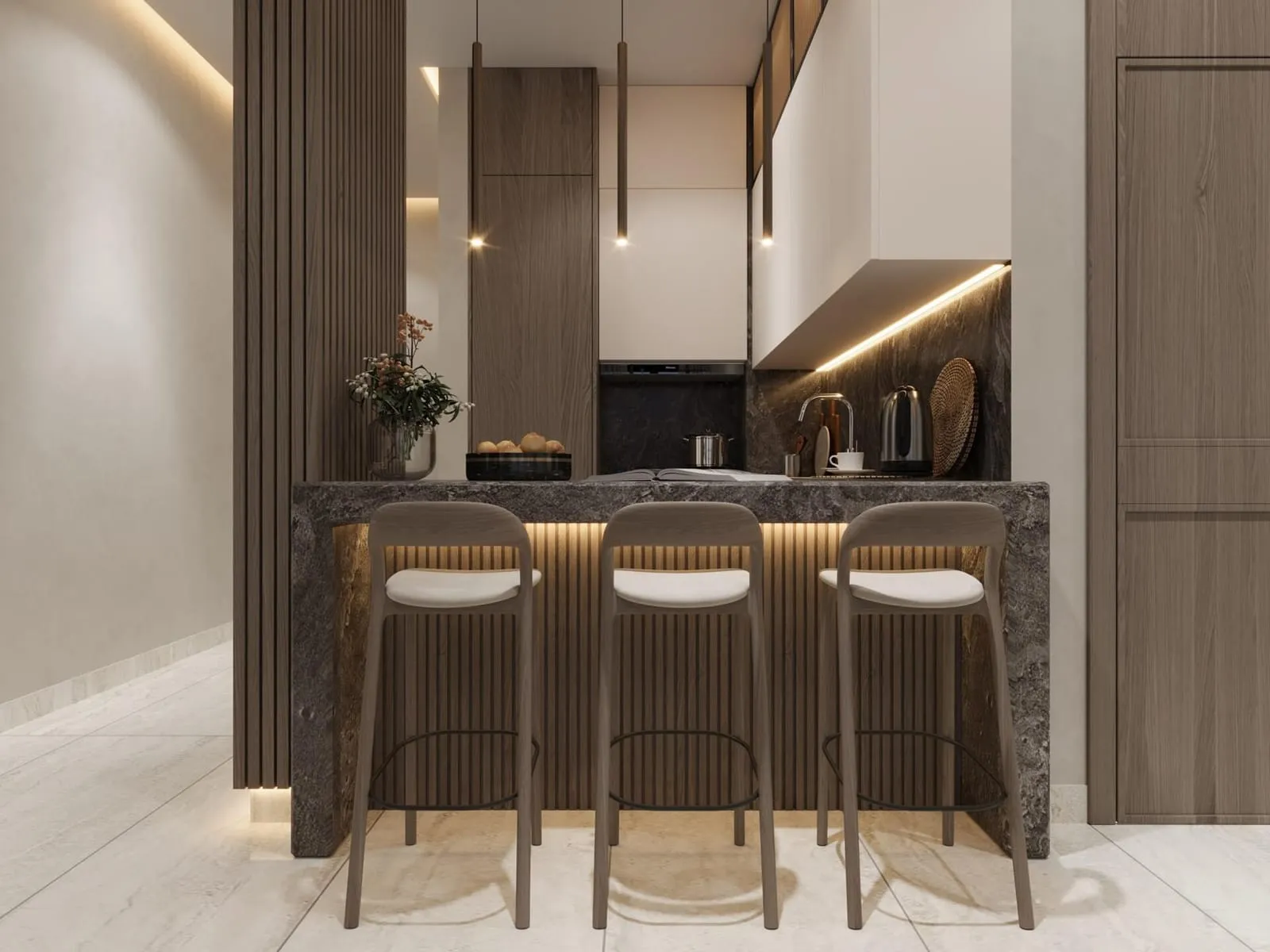 Marble breakfast bar with upholstered stools beneath warm pendant lighting