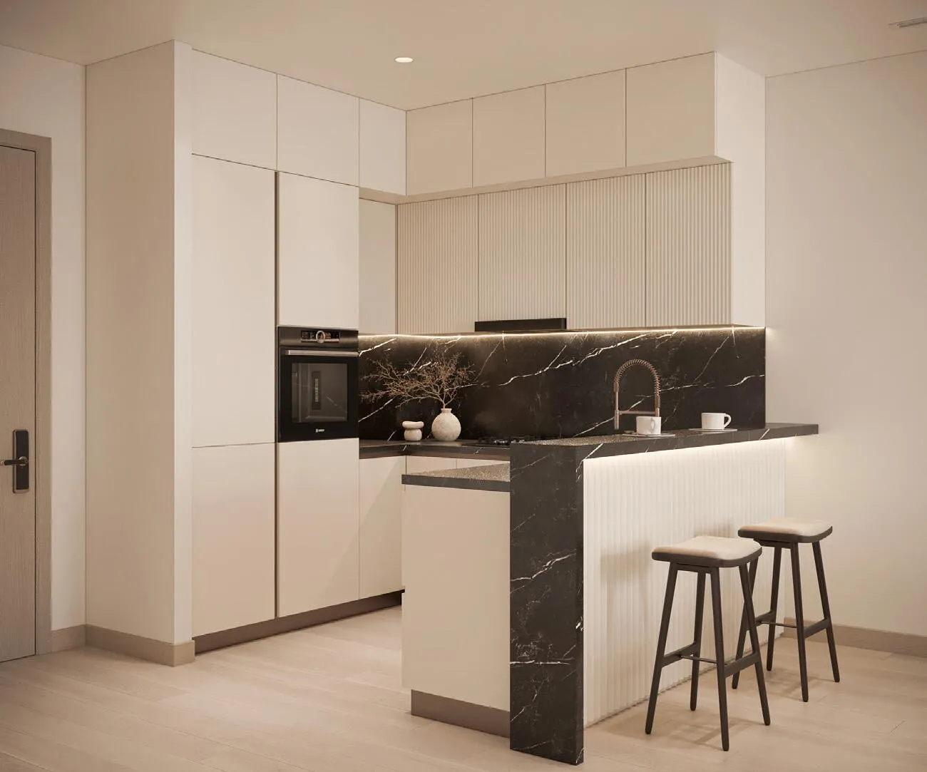 A kitchen with a dark stone island and bar stools set beneath pendant lighting