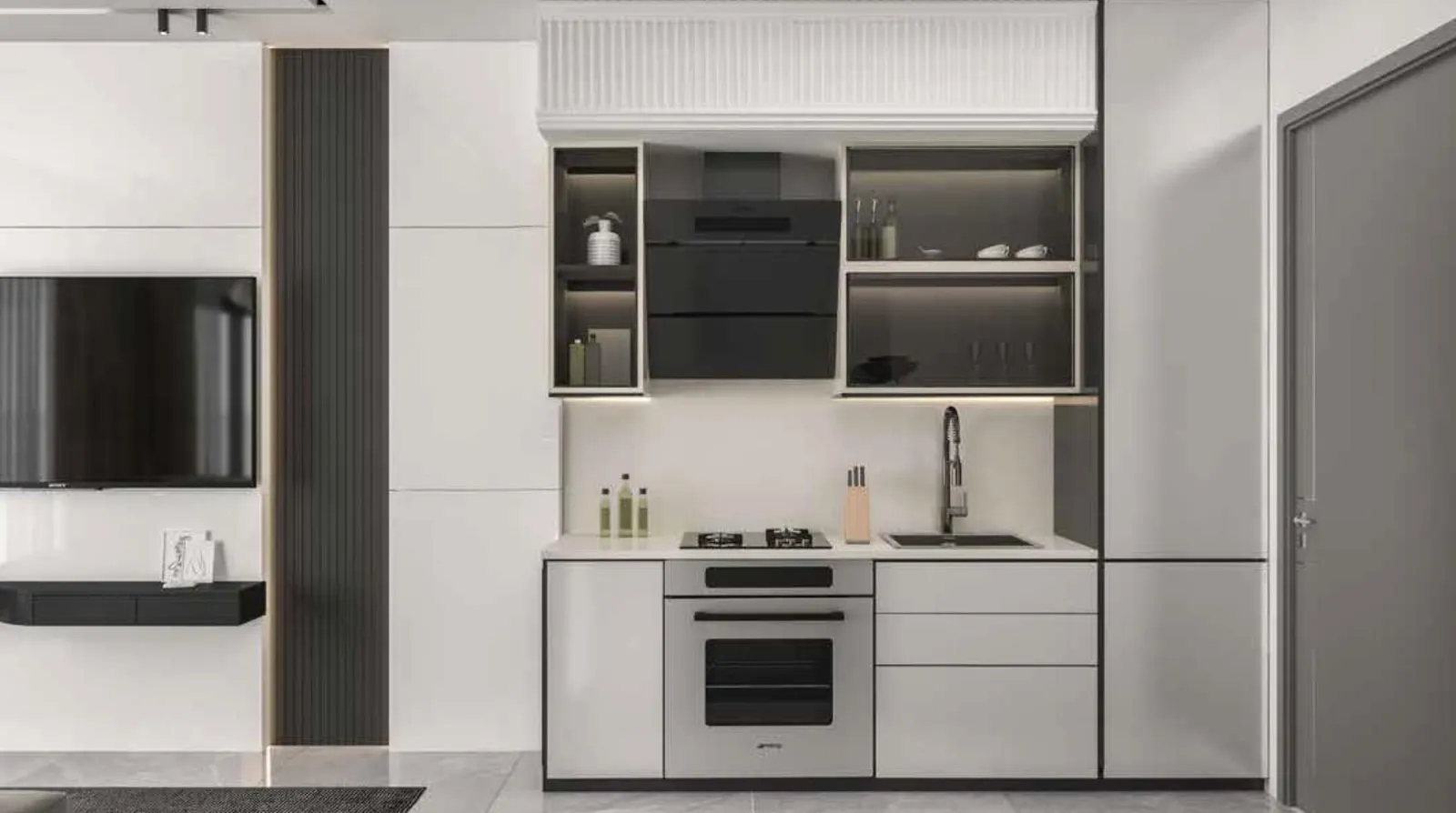A galley kitchen in pale cabinetry with a built-in oven, a dark panelled wall and a television opposite