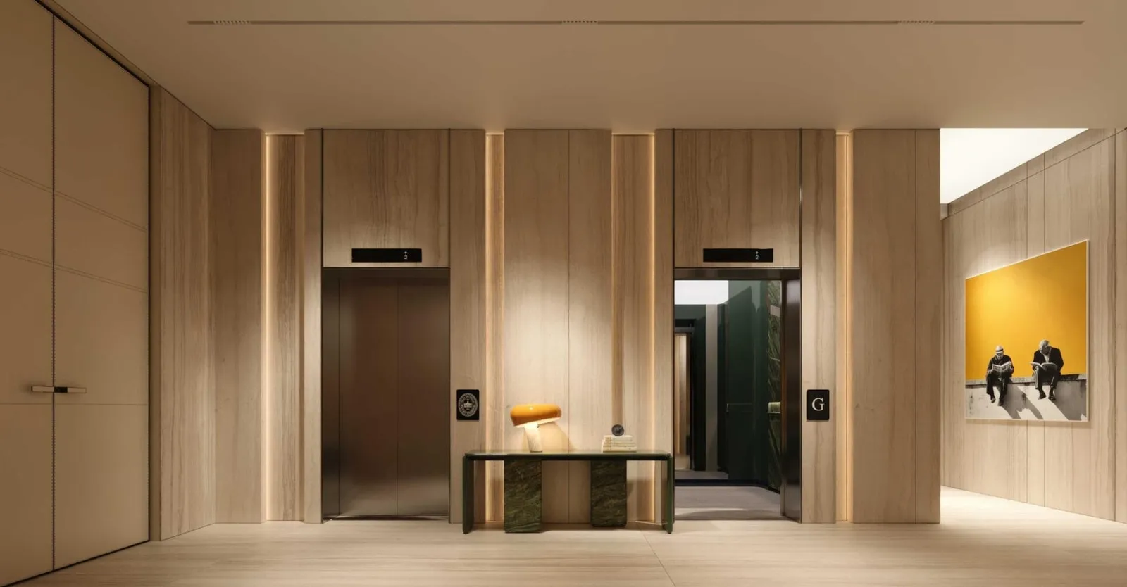The lift lobby in timber panelling, framed artwork facing the two lift doors