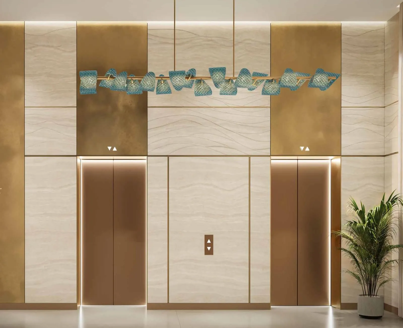 The lift lobby, brushed gold doors under a panel of glazed tiles with a planter to each side