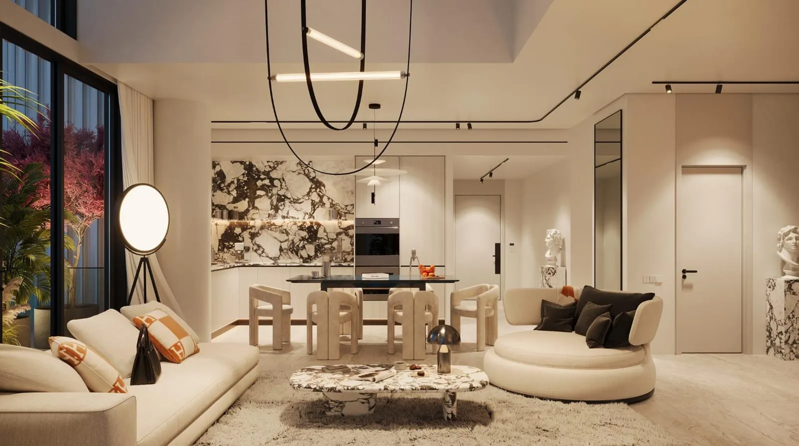 A living and dining room with a curved sofa, a round dining table and a sculptural chandelier above it