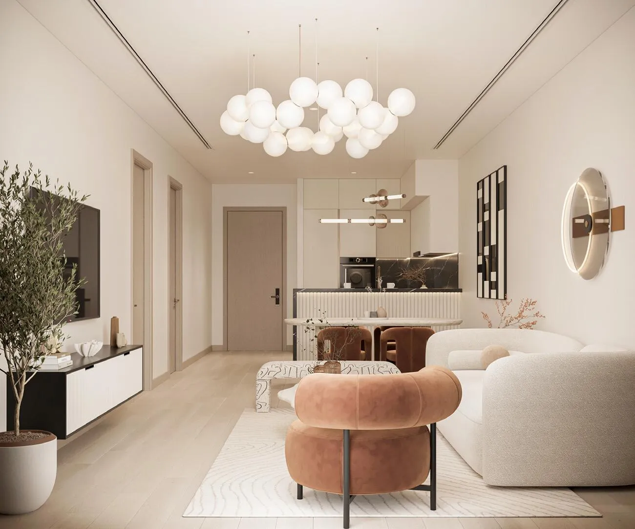 An open-plan living area with the kitchen visible behind, lit by a cluster of glass-bubble pendants