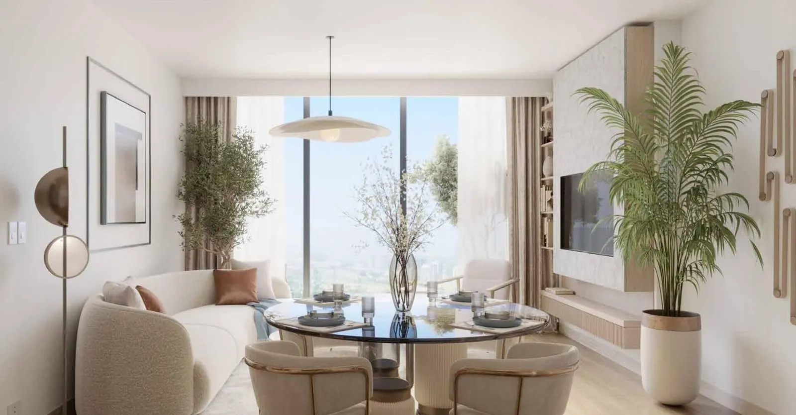 An open living and dining room, the round table laid for a meal and a sofa drawn up beside the window