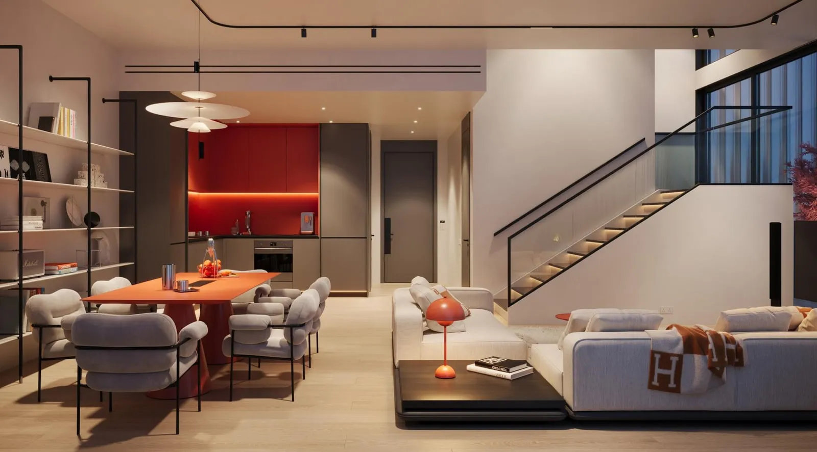 The open living and dining area of a duplex, the staircase rising behind the seating
