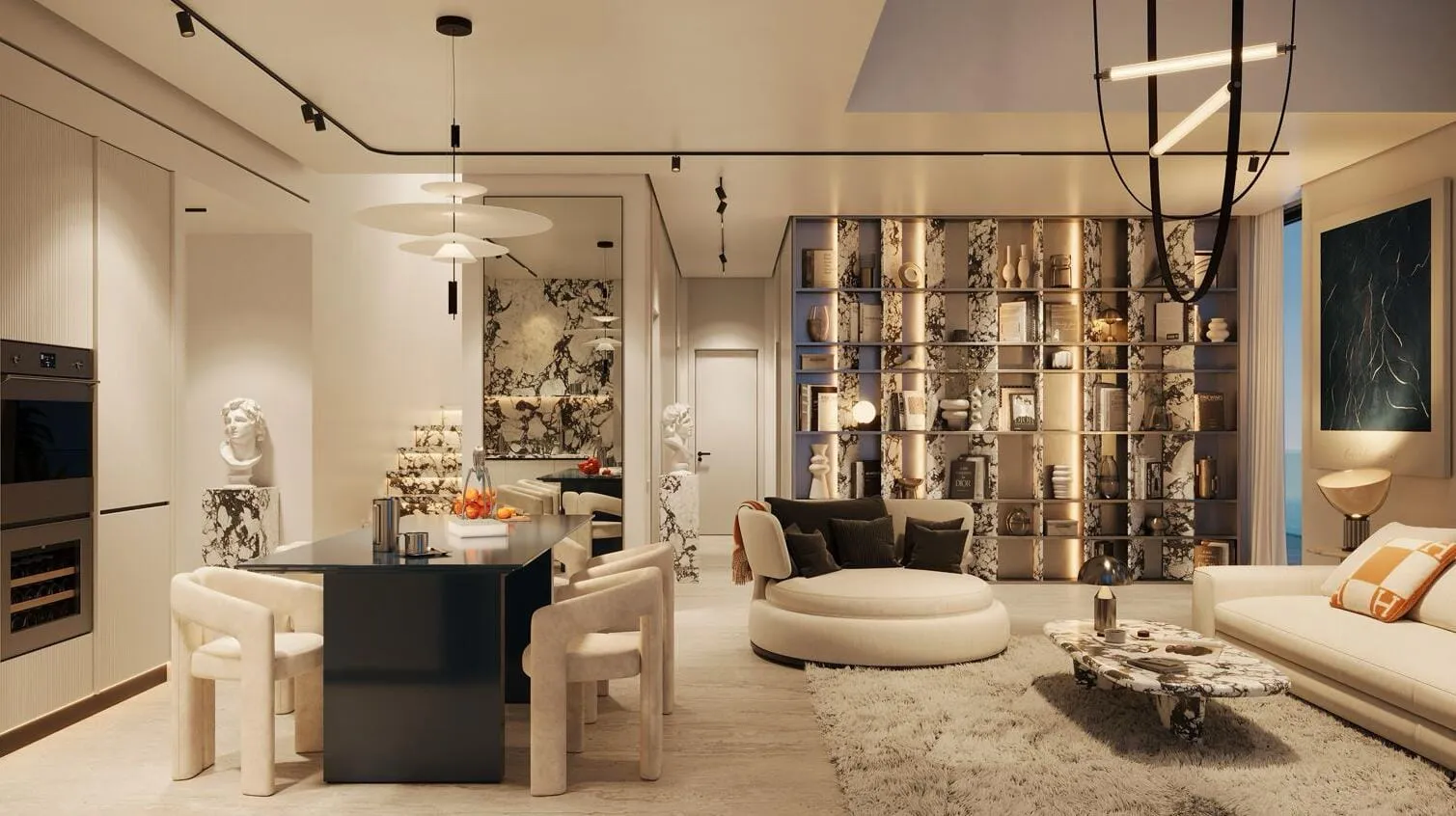 An open-plan living room and kitchen, a curved cream sofa facing a dark island counter beside a filigree screen