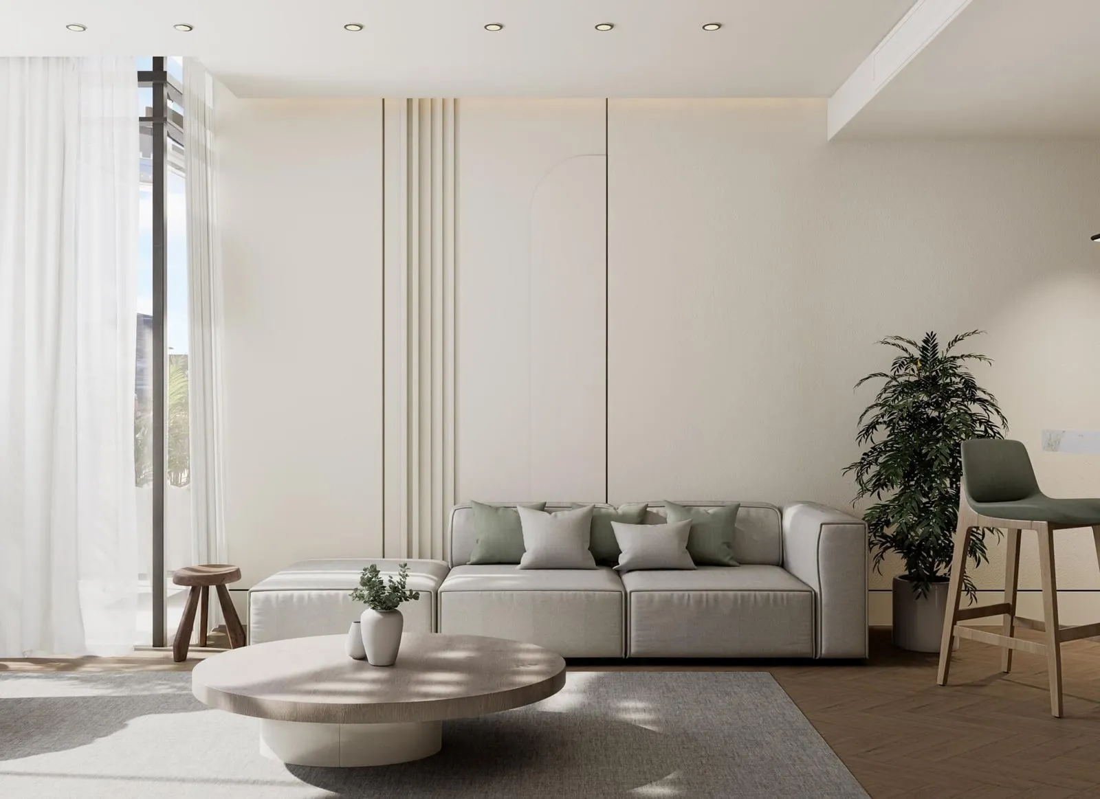 A bright, open-plan living room finished in soft white and beige tones with a curved coffee table