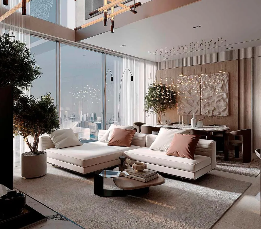 A living room behind full height glass, a pale sectional and an indoor tree with the city beyond