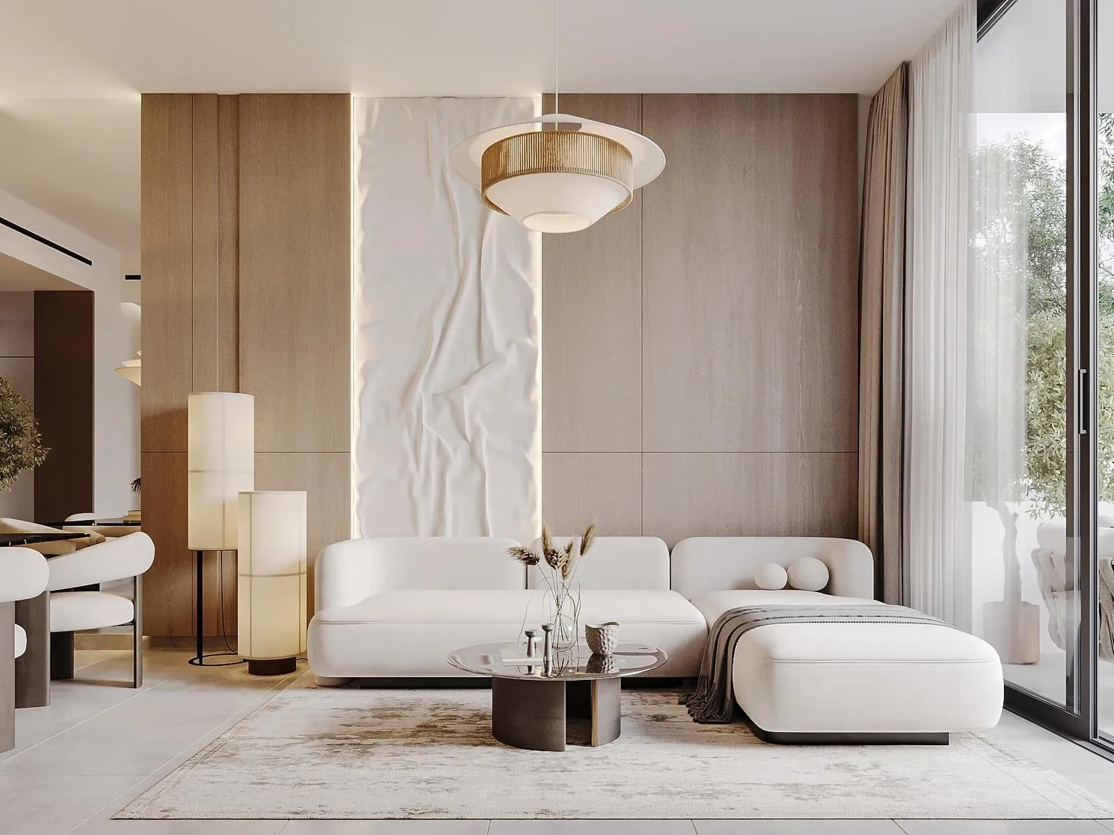 A living room with a curved cream sofa, a fluted stone wall and a low marble table
