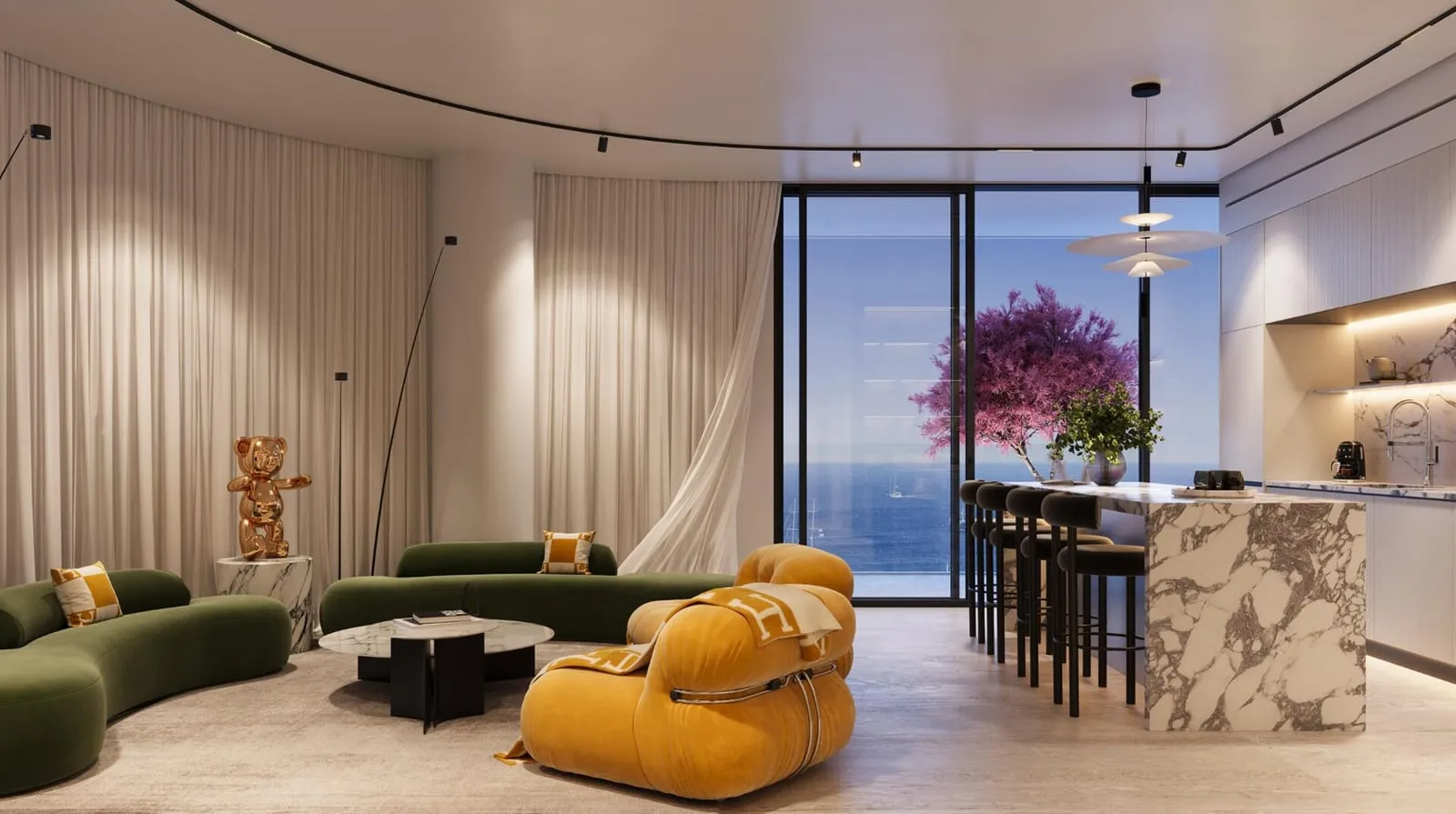 A living area with a green sofa and a yellow armchair, the marble kitchen island and a sea-facing window behind them