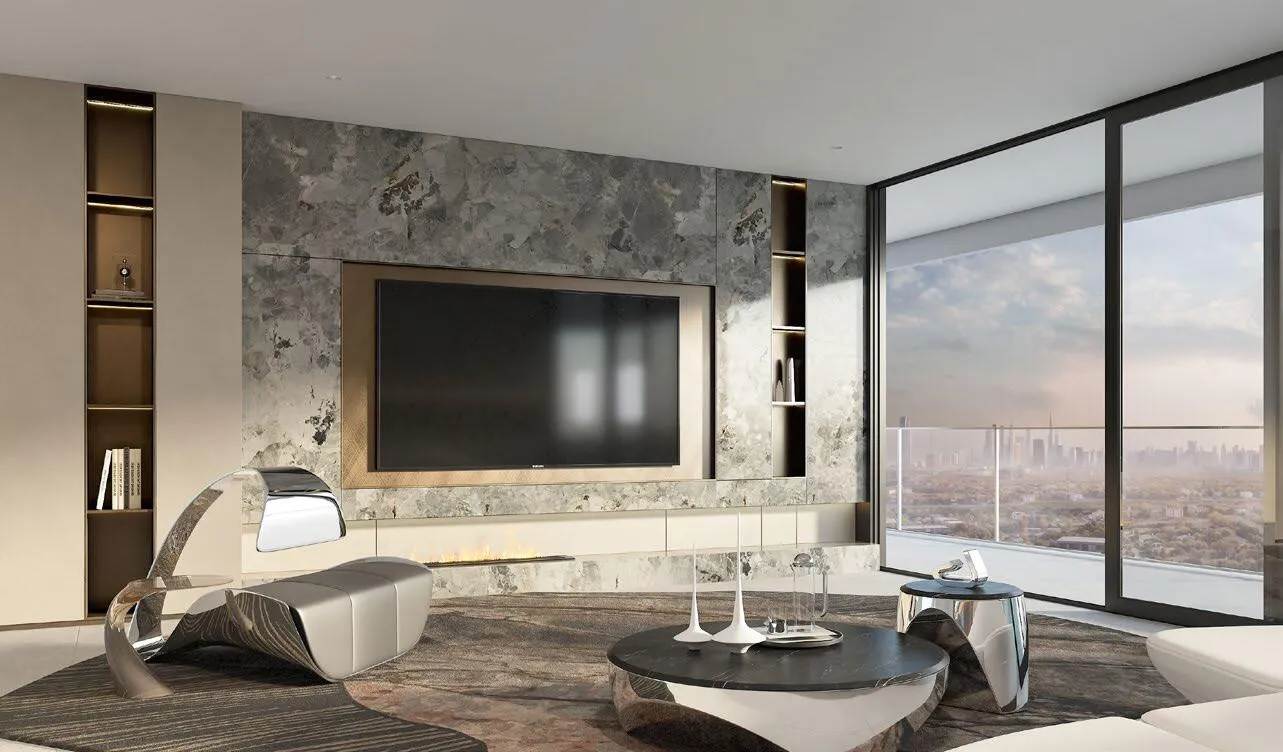 A living room facing a stone wall with a screen set into it, a low curved sofa and full height glass behind