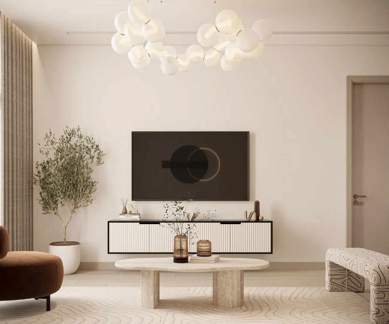 A living room with a wall-mounted television, a round coffee table and a rust-toned accent chair