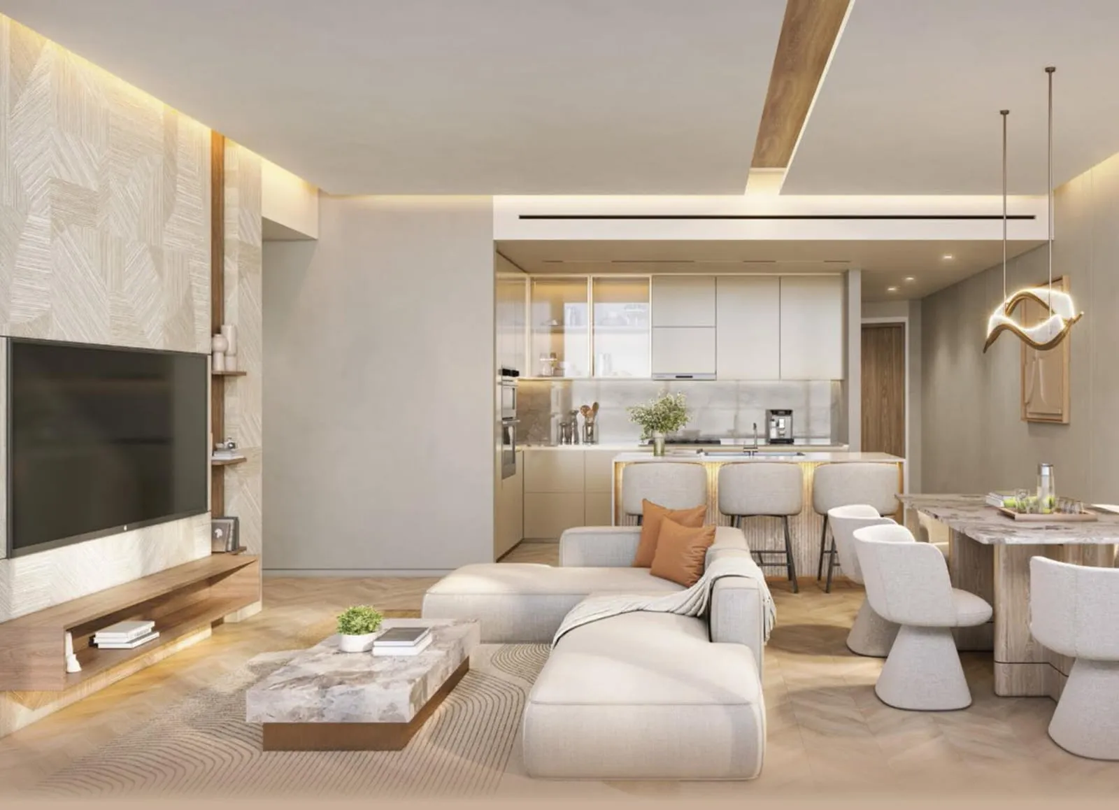 A living room with a textured stone panel behind the screen, a curved sofa and the open kitchen and dining table beyond