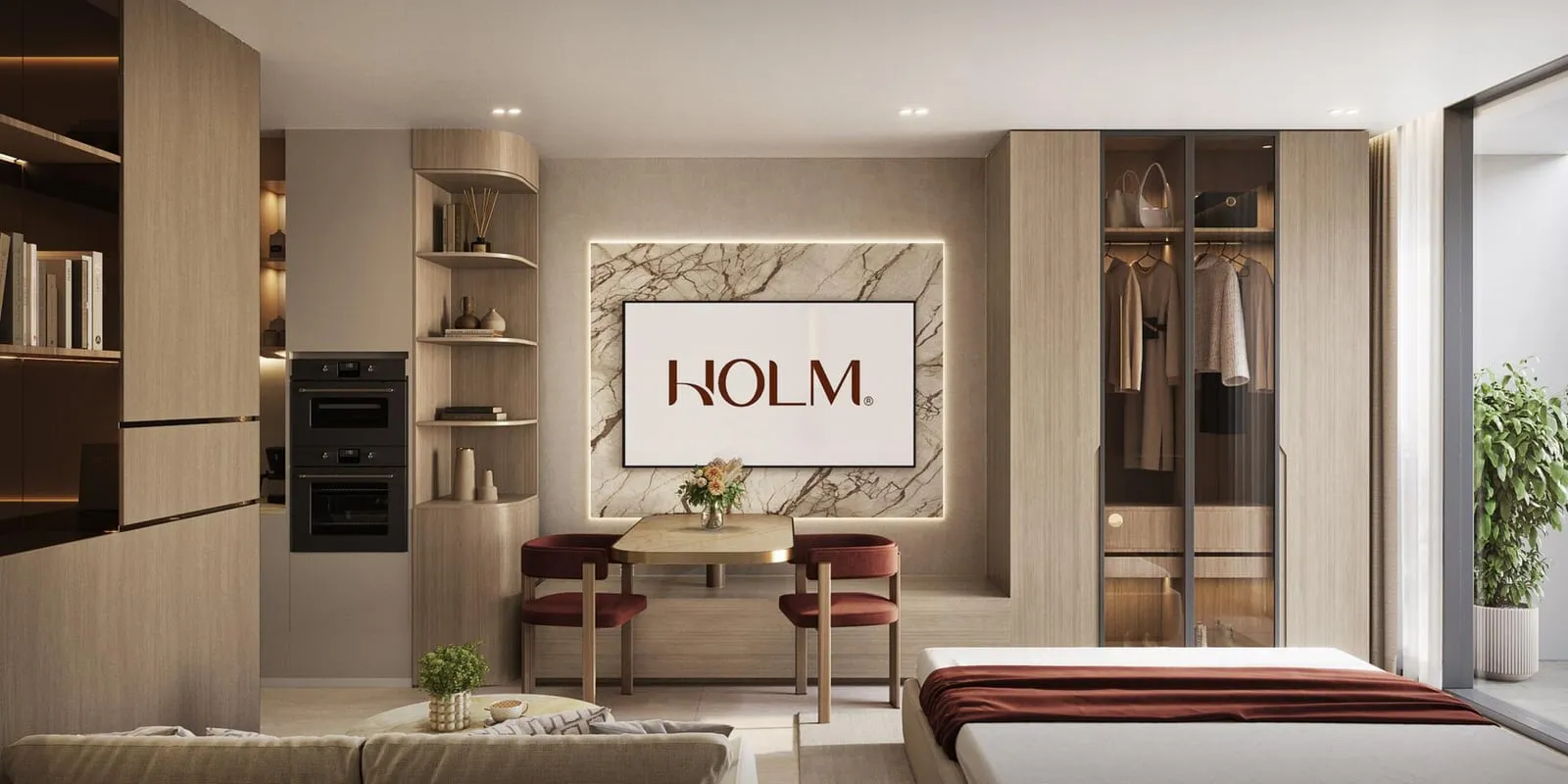 A living and sleeping space with a work desk, a red armchair and a framed HOLM print