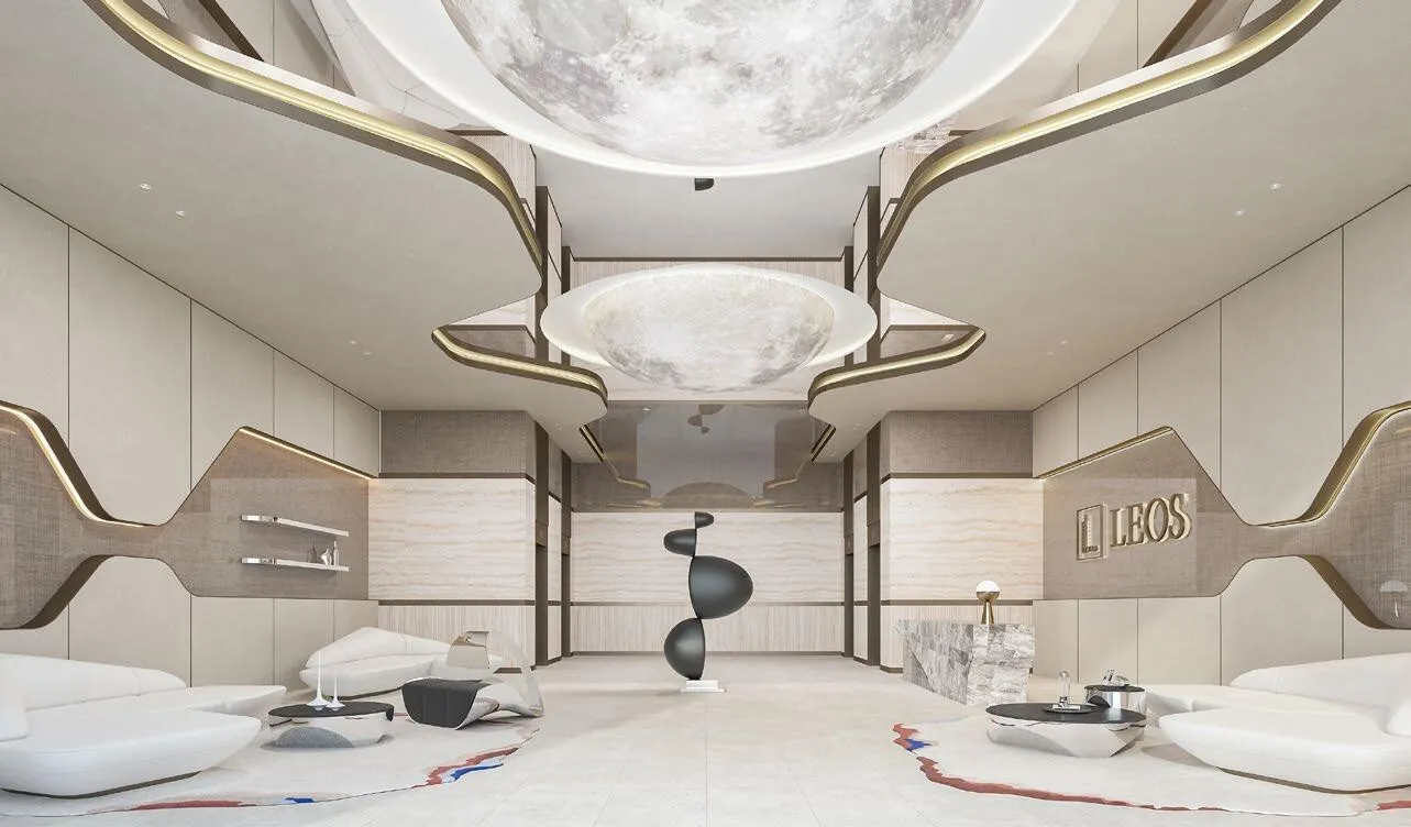 A white lobby under a domed ceiling light, sculptural seating below the developer name on the wall