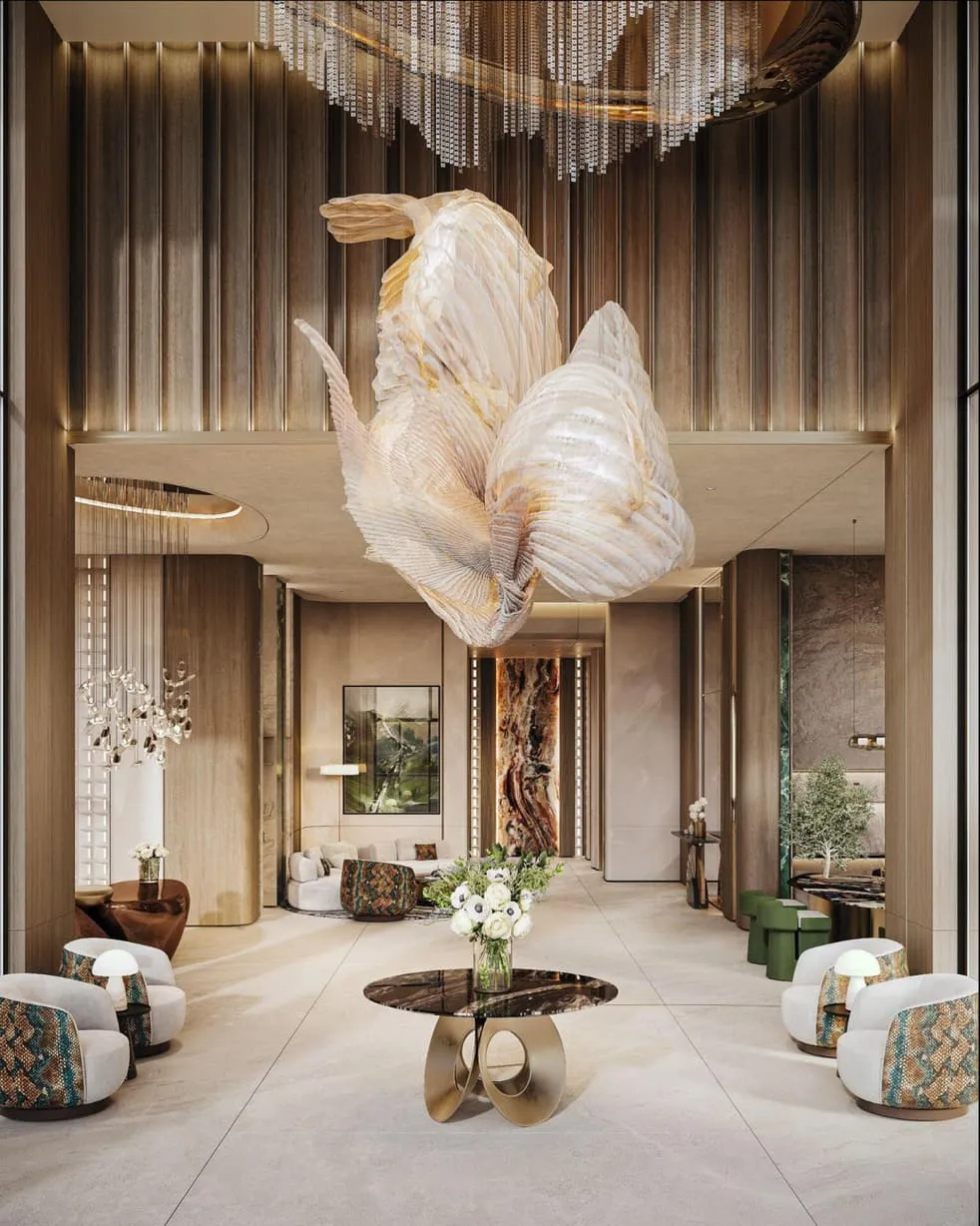 A lounge beneath a sculptural shell-shaped light fixture, seating gathered around a low table