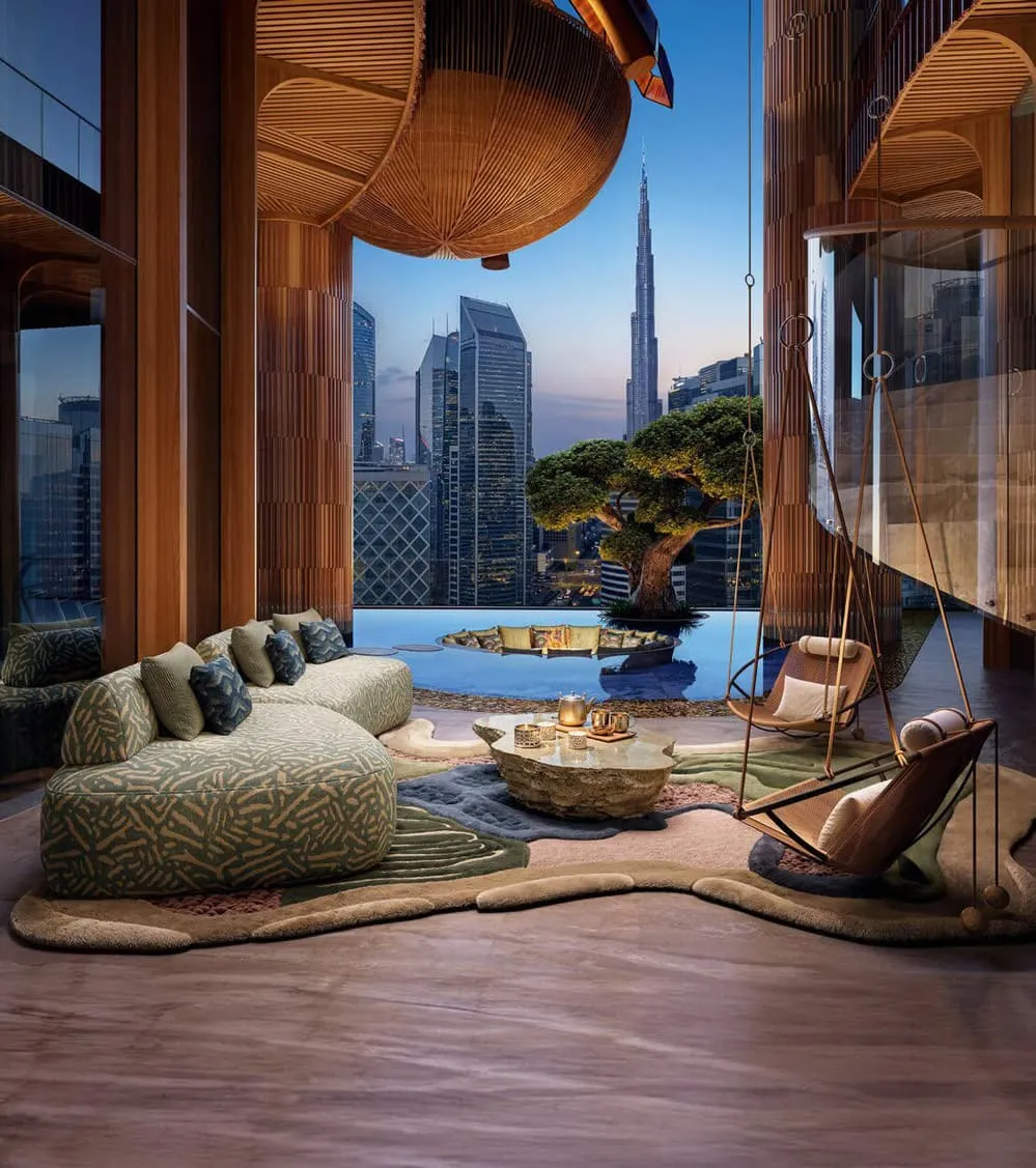 A lounge behind timber columns at dusk, the pool deck and the Burj Khalifa visible through the glass