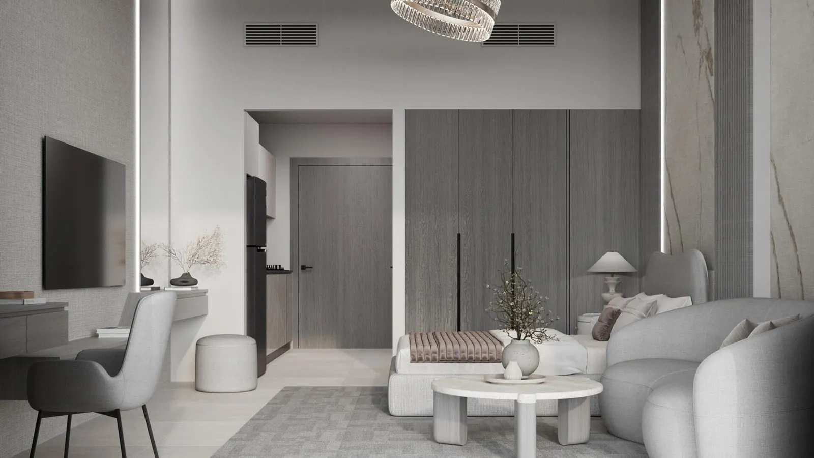 The open plan in the grey finish, a curved white sofa and round table with a desk and chair against the far wall