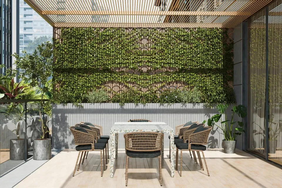 An outdoor dining terrace shaded by a wooden pergola draped in greenery