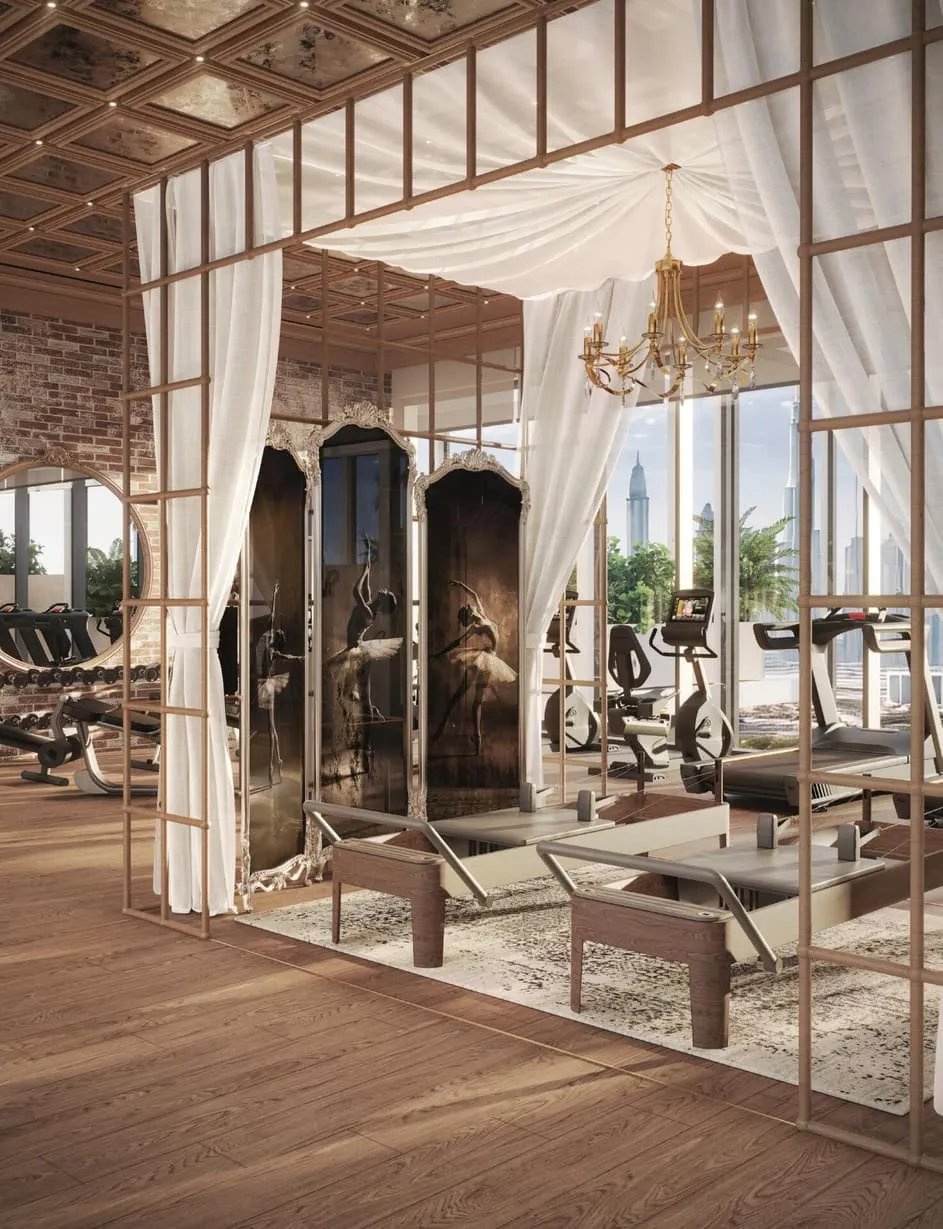 A pilates studio behind drawn drapes, reformer beds under a chandelier and antique mirrors along the wall