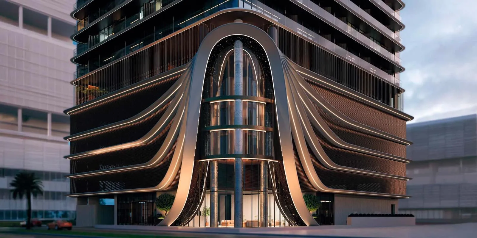 The podium in daylight, a tall arched opening framed by the bronze ribbons that fall down the front of the building