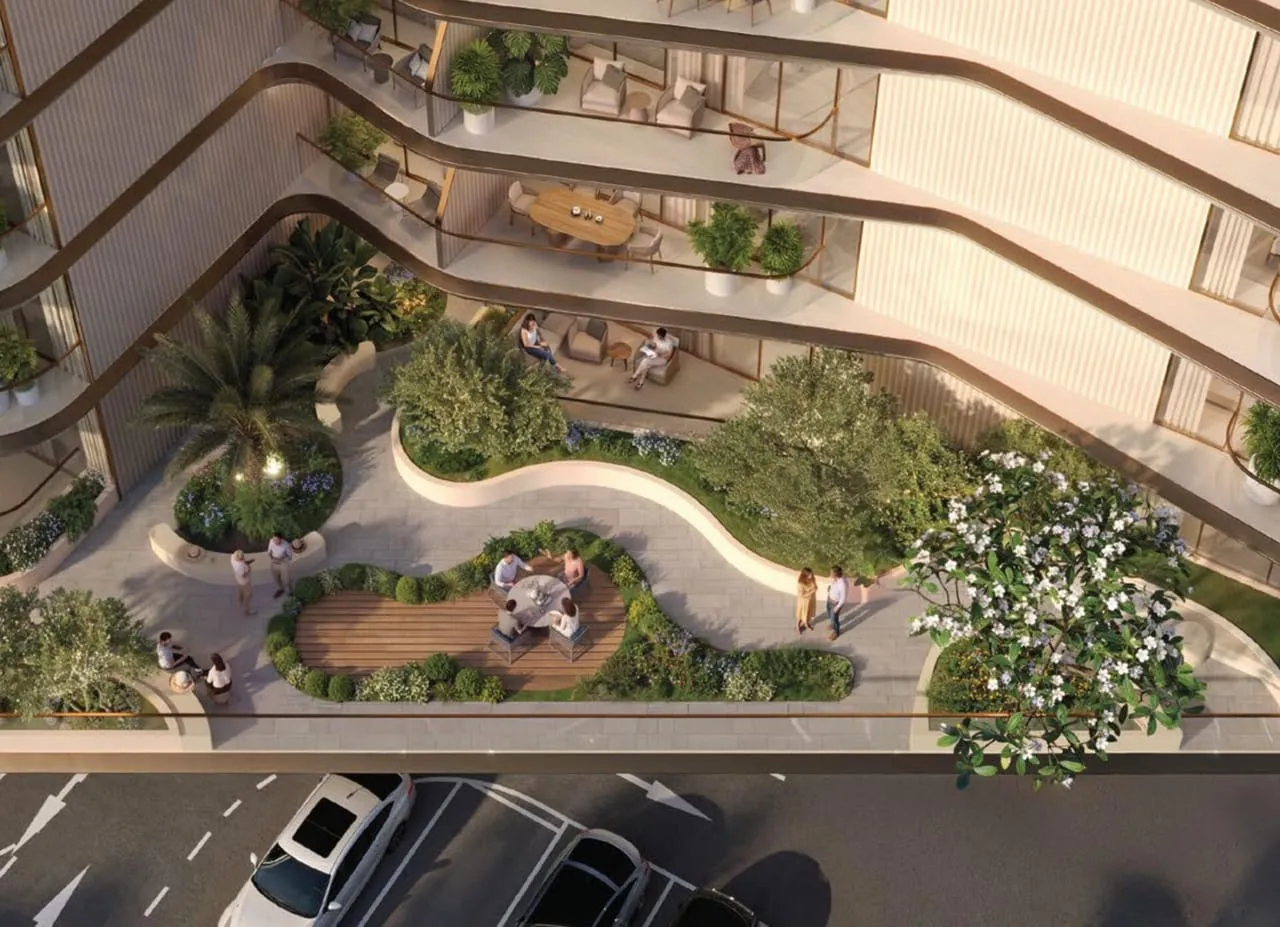 A garden terrace on the podium seen from above, curving paths and seating set into planting with the street below