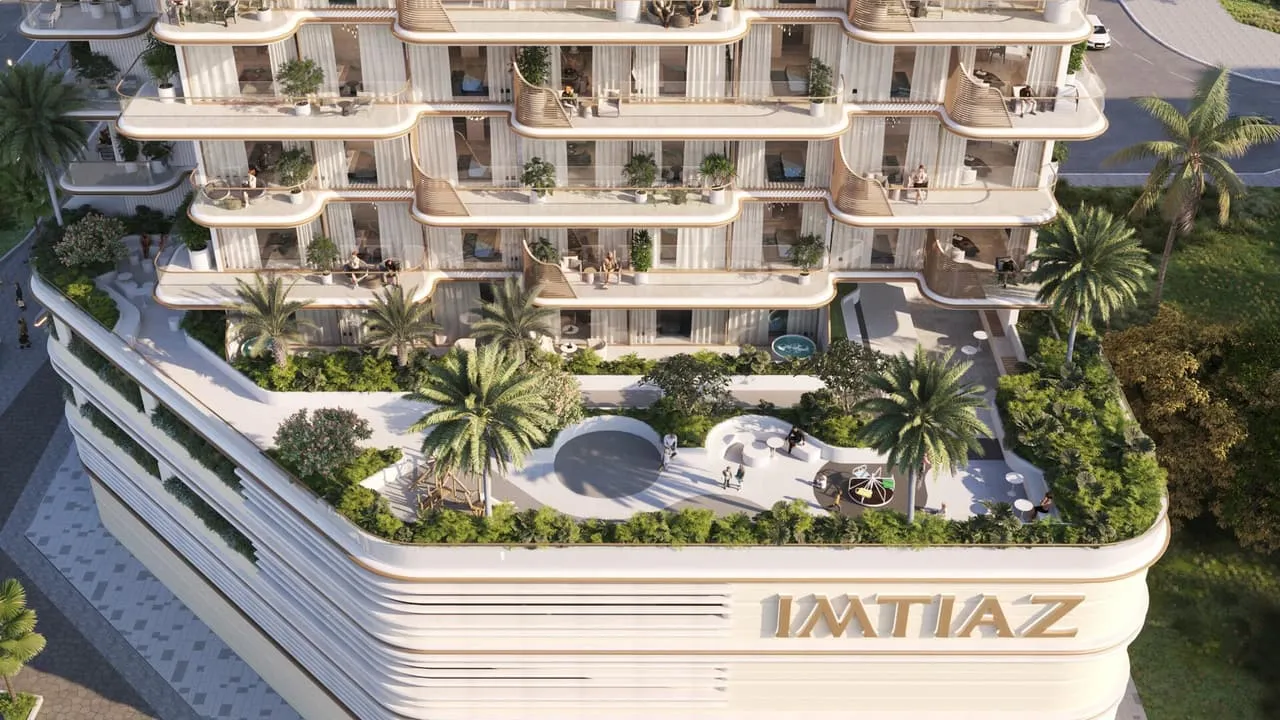 The pool deck on the podium, sun loungers along the water and the Imtiaz name lettered on the parapet