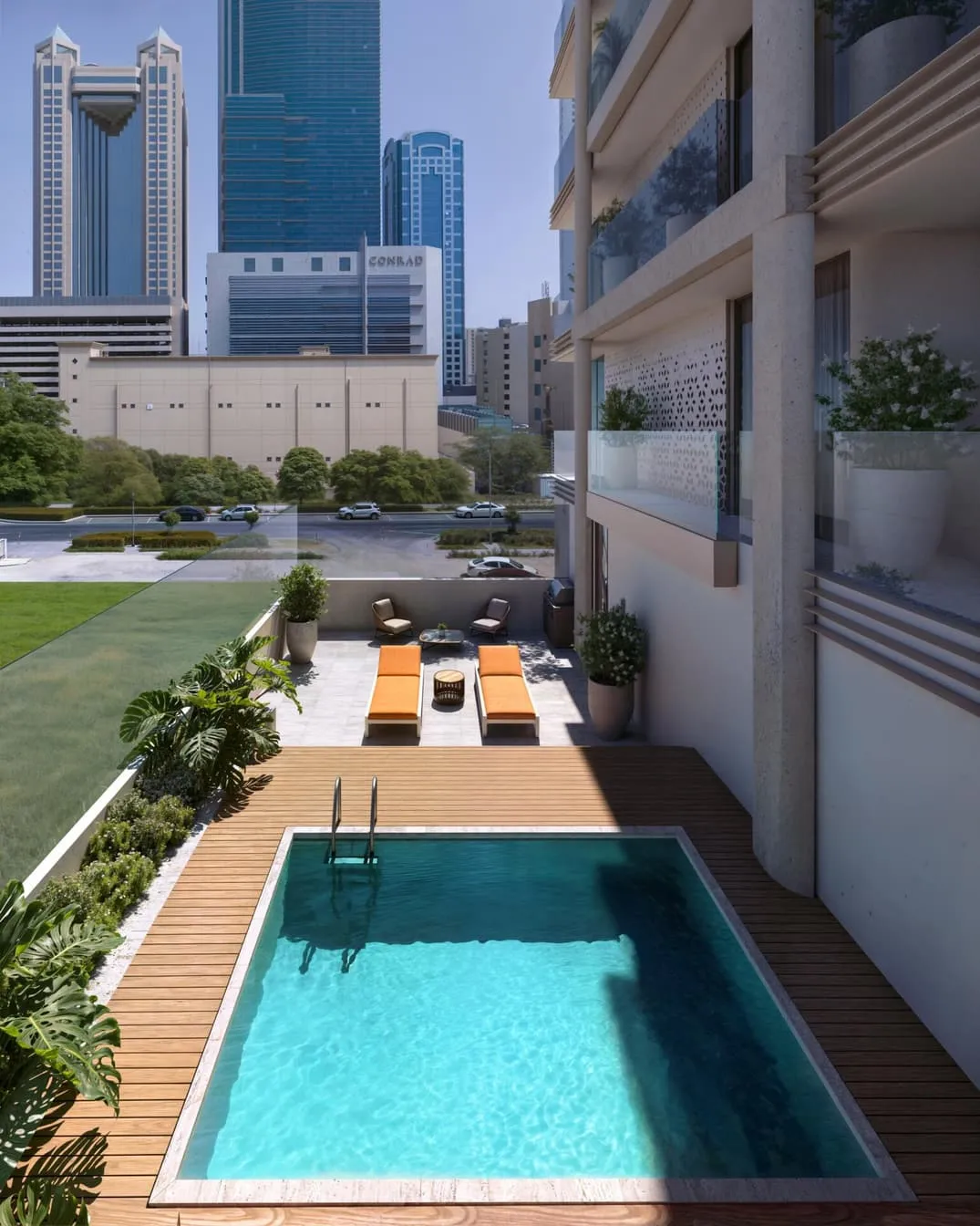 The podium pool from above at dusk, loungers on the deck and the towers of the business district behind