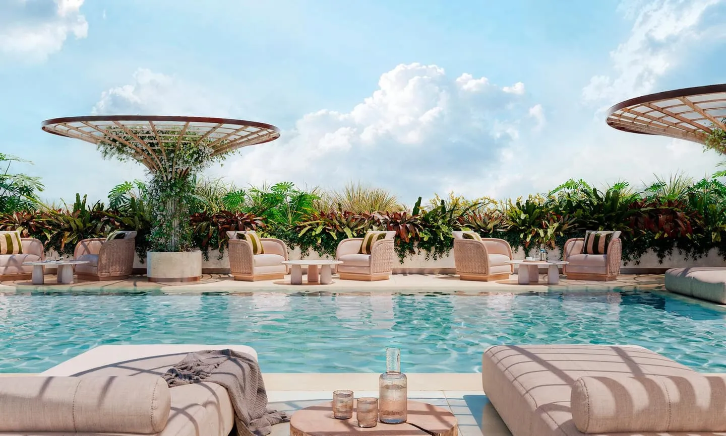 The swimming pool under sculpted parasol canopies, loungers and planting along its edge