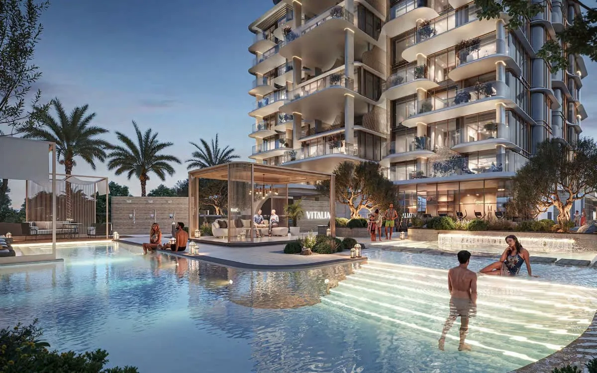 The communal pool in use, the building's balconies stepped above it