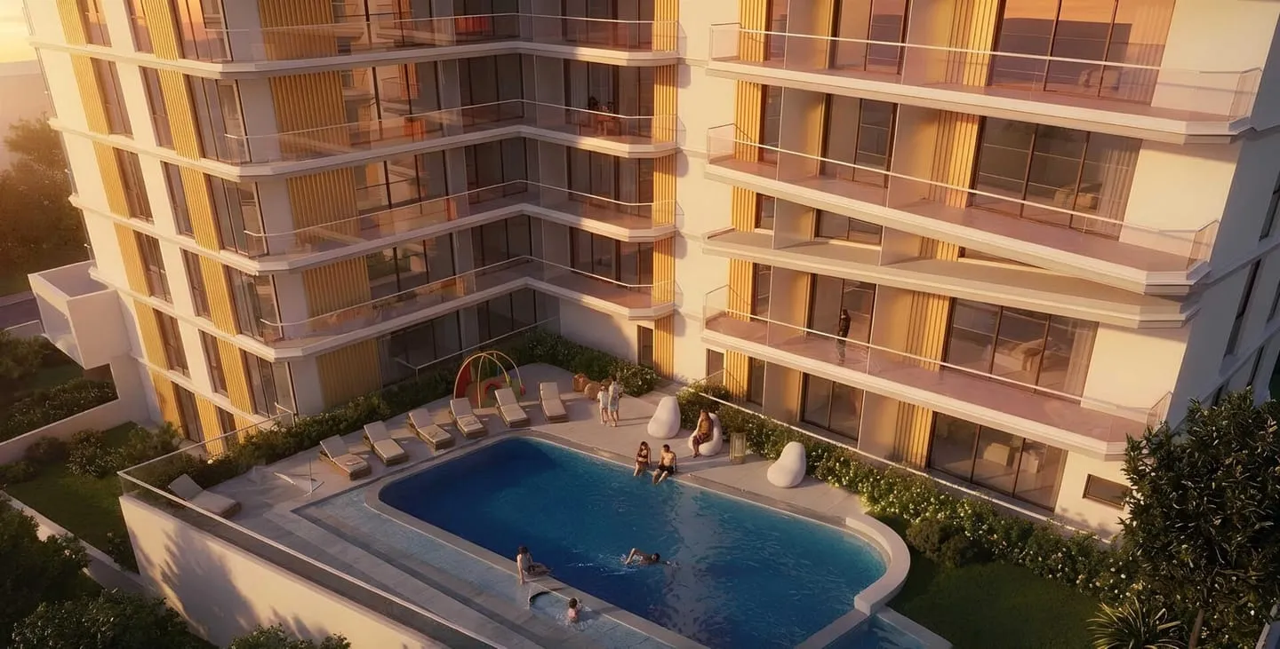 The pool deck seen from above, sun loungers set between the building's two wings