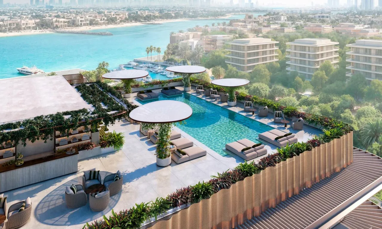 An aerial view of the pool deck, its parasol canopies and loungers set above the beach and the sea
