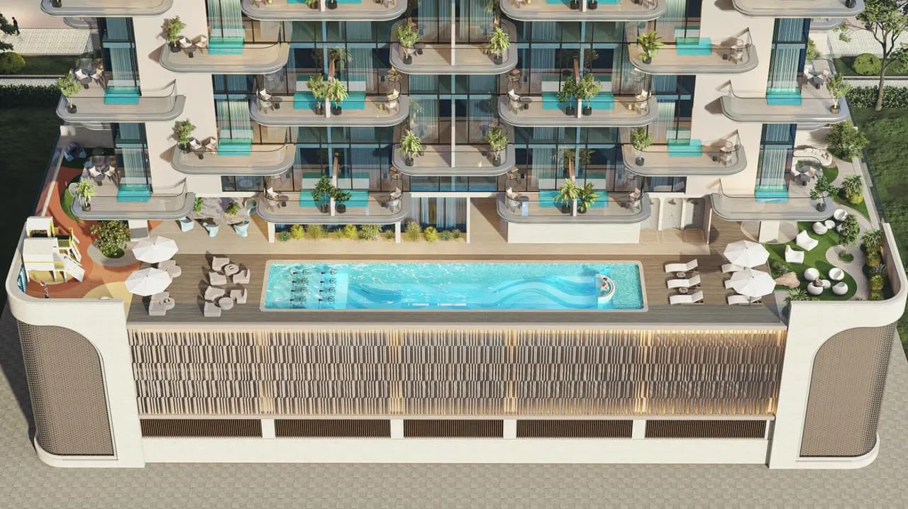 The pool deck seen from above, sun loungers lined along a long lap pool